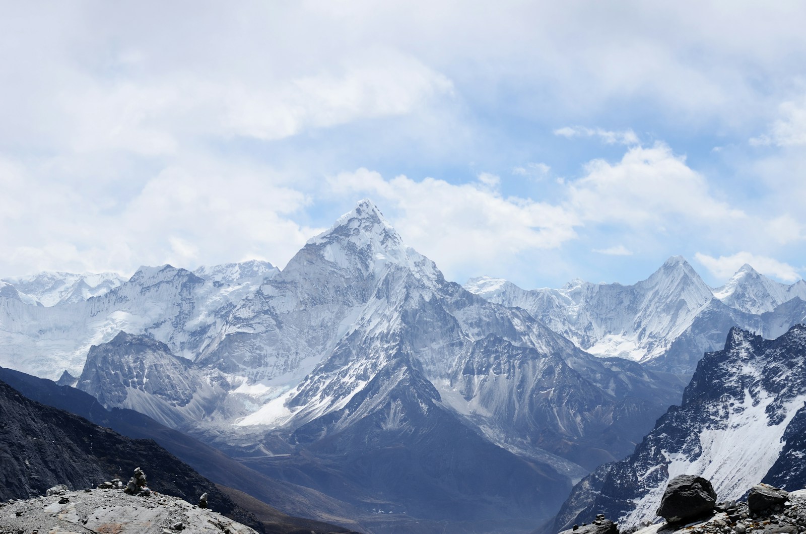 A snow-covered mountain peak above a rugged valley